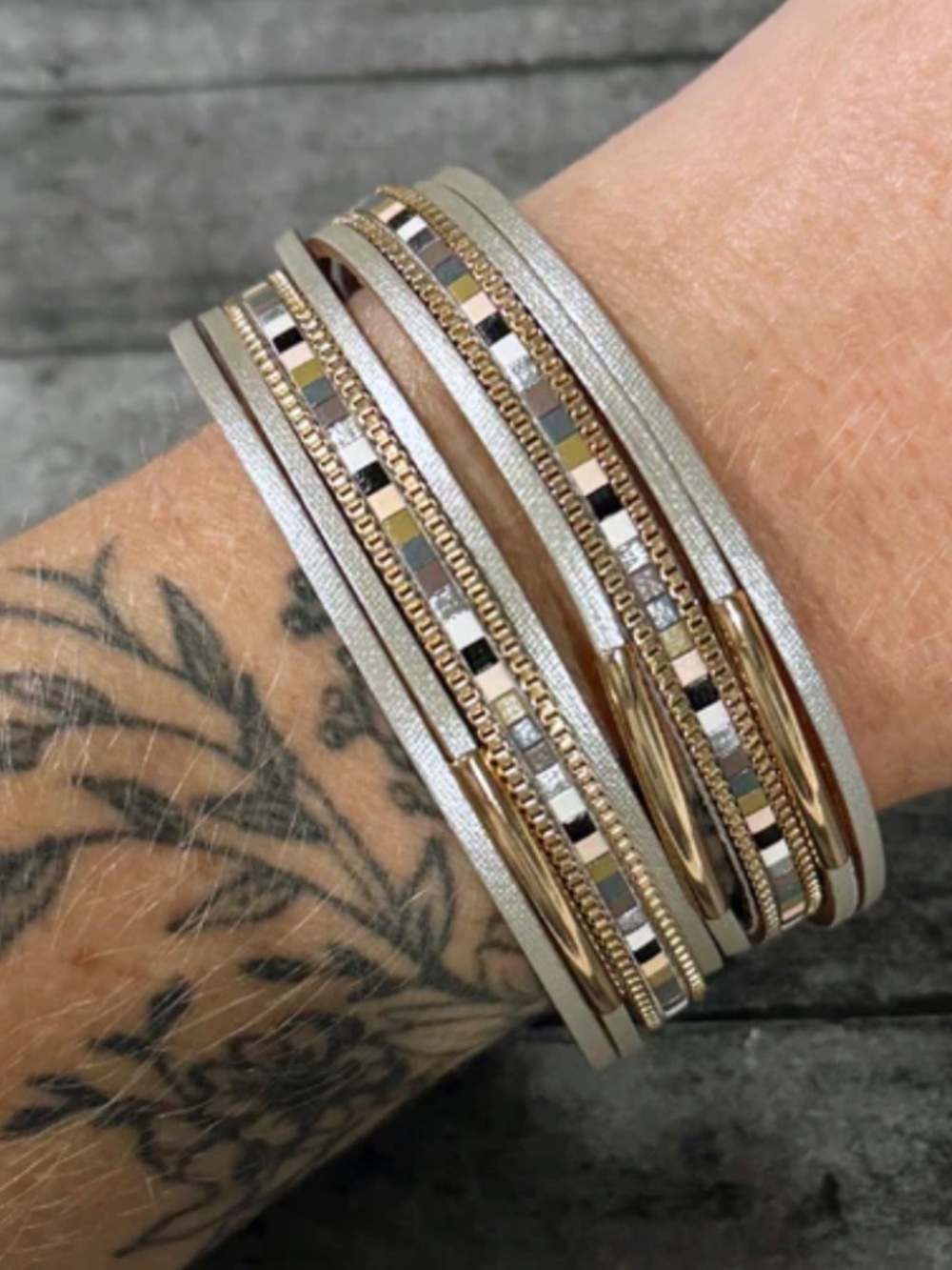 7.5" in length (7" fastened), the Neutral Metallic Leather Wrap Bracelet